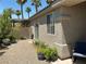 Cozy backyard features gravel, plants, a covered patio, and views of palm trees at 9753 Arrowcrest Ave, Las Vegas, NV 89147