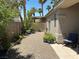 Enclosed backyard features desert landscaping, mature trees, and a covered patio at 9753 Arrowcrest Ave, Las Vegas, NV 89147