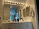 Elegant bathroom with a double sink vanity, stylish lighting, and a large mirror at 9753 Arrowcrest Ave, Las Vegas, NV 89147