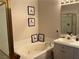 Bathroom featuring a relaxing tub with decorative art and a glass shower at 9753 Arrowcrest Ave, Las Vegas, NV 89147