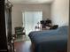 Bright bedroom featuring a sliding door, an oversized bed, and a desk area at 9753 Arrowcrest Ave, Las Vegas, NV 89147