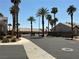 A view of the gated entrance to the community, enhanced by tall palm trees and landscaping at 9753 Arrowcrest Ave, Las Vegas, NV 89147