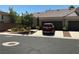 Charming home with a three-car garage, complemented by well-kept landscaping and a red car at 9753 Arrowcrest Ave, Las Vegas, NV 89147