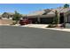 Spacious home featuring a three-car garage, complemented by desert landscaping and a red car at 9753 Arrowcrest Ave, Las Vegas, NV 89147