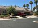 Attractive home with a three-car garage, complemented by desert landscaping and a red car at 9753 Arrowcrest Ave, Las Vegas, NV 89147