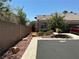 Well-kept home with desert landscaping, mature trees, and a classic aesthetic at 9753 Arrowcrest Ave, Las Vegas, NV 89147