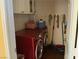 Cozy laundry room featuring a red washer and dryer set and storage space at 9753 Arrowcrest Ave, Las Vegas, NV 89147