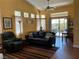 Comfortable living room featuring a ceiling fan, sliding glass doors, and vaulted ceilings for a spacious feel at 9753 Arrowcrest Ave, Las Vegas, NV 89147