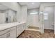Elegant bathroom with a double sink vanity and a glass-enclosed shower with stone flooring at 977 Edinburgh Fields Ct, Las Vegas, NV 89138