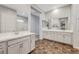 Spacious bathroom featuring dual vanities, large mirrors, and tile floors at 977 Edinburgh Fields Ct, Las Vegas, NV 89138