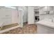 Bathroom featuring tiled floors, a glass-walled shower with seat, and an adjacent walk-in closet at 977 Edinburgh Fields Ct, Las Vegas, NV 89138