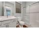 Modern bathroom featuring a white vanity, a toilet and a tiled shower with glass doors at 977 Edinburgh Fields Ct, Las Vegas, NV 89138