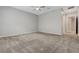 Spacious bedroom featuring neutral-toned walls, plush carpeting, and a ceiling fan for added comfort at 977 Edinburgh Fields Ct, Las Vegas, NV 89138