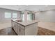 Open-concept kitchen with large island, stainless steel sink, and views into a living space at 977 Edinburgh Fields Ct, Las Vegas, NV 89138