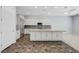 Modern kitchen with white cabinets, stainless steel appliances, and a large center island at 977 Edinburgh Fields Ct, Las Vegas, NV 89138