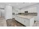 Bright kitchen featuring a large island, stainless steel appliances, and white cabinetry at 977 Edinburgh Fields Ct, Las Vegas, NV 89138