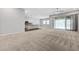 Expansive living room flowing into a modern kitchen with stainless steel appliances and a large island at 977 Edinburgh Fields Ct, Las Vegas, NV 89138