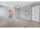 Spacious living room with neutral tones, ceiling fan, and a large front door at 977 Edinburgh Fields Ct, Las Vegas, NV 89138
