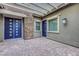Cozy patio with blue doors, stone accents, and a covered pergola, perfect for outdoor living at 977 Edinburgh Fields Ct, Las Vegas, NV 89138