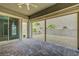 Relaxing covered patio featuring brick flooring and open access to the outdoor space and desert landscaping at 977 Edinburgh Fields Ct, Las Vegas, NV 89138