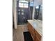 Bathroom with walk-in shower, dual vanity, wood cabinets, and wood-look floors at , Henderson, NV 89002