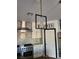 Modern kitchen with stainless steel appliances, white cabinets, and stylish lighting at , Henderson, NV 89002