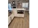 Gourmet kitchen with stainless steel appliances, white cabinets, and a stone accent wall at , Henderson, NV 89002
