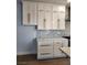 Custom white kitchen cabinets with gold hardware and mosaic backsplash at , Henderson, NV 89002