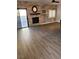 Spacious living area with wood flooring, stone accent wall, and a cozy fireplace at , Henderson, NV 89002