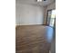 A spacious living room with wood floors and sliding glass doors to a balcony at , Henderson, NV 89002