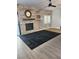 Open living room featuring a fireplace with stone accent wall, ceiling fan, and modern flooring at , Henderson, NV 89002