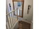 Staircase with wooden steps and railings, featuring a large ornate mirror on the wall at , Henderson, NV 89002