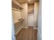 A well-designed walk-in closet with wood shelving and wood-look flooring offers ample storage space at , Henderson, NV 89002