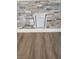 Detail of the stone accent wall with hidden compartment, modern flooring, and clean trim at , Henderson, NV 89002