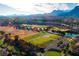 Expansive aerial view of a golf course community with houses, lakes, and mountain views at 10125 Hope Island Dr, Las Vegas, NV 89134