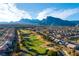 Aerial view of Highland Falls Golf Club with mountain views on a bright sunny day at 10125 Hope Island Dr, Las Vegas, NV 89134