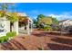 Beautifully landscaped backyard featuring mature trees and a covered patio, perfect for relaxing at 10125 Hope Island Dr, Las Vegas, NV 89134
