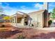 The backyard features a covered patio and beautifully designed desert landscaping at 10125 Hope Island Dr, Las Vegas, NV 89134