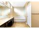 Well-lit bathroom with dual sinks, a soaking tub, and tile flooring at 10125 Hope Island Dr, Las Vegas, NV 89134