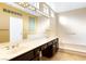 Large primary bathroom with double vanity, soaking tub, and bright lighting at 10125 Hope Island Dr, Las Vegas, NV 89134
