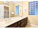 Dual sink bathroom vanity with solid surface countertop and tiled floor at 10125 Hope Island Dr, Las Vegas, NV 89134