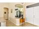 Inviting entryway featuring neutral walls, tile floors, and decorative display with a mirrored backdrop and a view of the dining room at 10125 Hope Island Dr, Las Vegas, NV 89134
