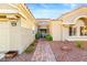 Charming single Gathering home showcasing a stone pathway leading to the gated front entrance, desert landscaping and a two car garage at 10125 Hope Island Dr, Las Vegas, NV 89134