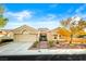 Charming single-story home with desert landscaping, tile roof, and an attached two-car garage at 10125 Hope Island Dr, Las Vegas, NV 89134