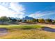 Picturesque view of the golf course with manicured greens, sand traps, and mountain backdrop at 10125 Hope Island Dr, Las Vegas, NV 89134