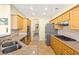 Well-equipped kitchen with stainless steel appliances, tile backsplash, and ample wood cabinetry at 10125 Hope Island Dr, Las Vegas, NV 89134