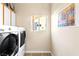 Bright laundry room with front-loading washer and dryer, and a window for natural light at 10125 Hope Island Dr, Las Vegas, NV 89134