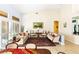 Spacious living room with neutral-tone walls, tiled floors, plantation shutters, comfortable seating, and an open layout at 10125 Hope Island Dr, Las Vegas, NV 89134
