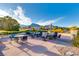 Outdoor seating area with tables and chairs at Highland Falls Golf Course with mountain views at 10125 Hope Island Dr, Las Vegas, NV 89134