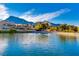 Scenic pond view with mountains in the background and lush landscaping at 10125 Hope Island Dr, Las Vegas, NV 89134